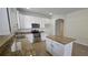 Bright kitchen featuring white cabinets, granite countertops, stainless steel appliances, and an island for added prep space at 2528 Ladoga Dr, Lakeland, FL 33805