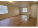 Spacious living room with beautiful wood-look flooring and large windows offering ample natural light at 2528 Ladoga Dr, Lakeland, FL 33805
