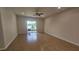 Spacious living room with ceiling fan, tile floor and sliding glass doors leading to a balcony with lake views at 2528 Ladoga Dr, Lakeland, FL 33805