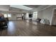 Bright meeting room with wood flooring, a skylight, tables and chairs, and a wall-mounted television at 2528 Ladoga Dr, Lakeland, FL 33805