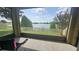 Screened-in patio with tranquil lake views, perfect for outdoor seating and relaxation at 2528 Ladoga Dr, Lakeland, FL 33805