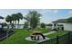 Community picnic area with picnic tables on concrete pads overlooks a lake and has mature landscaping at 2528 Ladoga Dr, Lakeland, FL 33805
