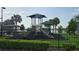 Community playground featuring a covered play structure, slides and mature landscaping near a lake at 2528 Ladoga Dr, Lakeland, FL 33805