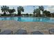 Community pool with lounge chairs and seating areas offers a refreshing escape on a sunny day at 2528 Ladoga Dr, Lakeland, FL 33805