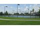 View of the fenced community tennis courts on a partly cloudy day at 2528 Ladoga Dr, Lakeland, FL 33805