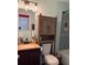 Bathroom featuring stylish vanity, updated lighting, and tiled shower over tub at 3435 Swindell Rd, Lakeland, FL 33810