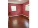 Cozy bedroom with hardwood floors and ample natural light from two windows at 3435 Swindell Rd, Lakeland, FL 33810