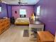 Bright bedroom with laminate flooring, fan, and custom built-in furniture at 3435 Swindell Rd, Lakeland, FL 33810