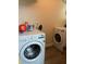 Efficient laundry room with front loading washer and dryer set on wood grain flooring at 3435 Swindell Rd, Lakeland, FL 33810