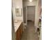 Well-lit bathroom featuring tiled floors, vanity with wood cabinets and a closet for convenient storage at 9053 Lee Vista Blvd # 1405, Orlando, FL 32829
