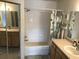 Bathroom featuring a shower-tub combo with tiled walls and a single sink vanity at 9053 Lee Vista Blvd # 1405, Orlando, FL 32829