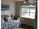Cozy bedroom featuring a bed, dresser, and scenic views of the water at 9053 Lee Vista Blvd # 1405, Orlando, FL 32829