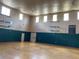Indoor gymnasium featuring a basketball court with hoops, natural light from multiple windows, and high ceilings at 9053 Lee Vista Blvd # 1405, Orlando, FL 32829