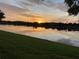 Tranquil lakeside view at sunset, creating a picturesque and relaxing environment at 9053 Lee Vista Blvd # 1405, Orlando, FL 32829