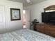 Bright bedroom featuring a large dresser, a large TV and lots of natural light at 9053 Lee Vista Blvd # 1405, Orlando, FL 32829
