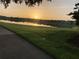 Breathtaking sunrise view over a serene pond reflecting distant houses, surrounded by lush greenery at 9053 Lee Vista Blvd # 1405, Orlando, FL 32829