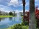 Beautiful community pond with fountain, palm trees, lush landscaping, and serene water views creating a peaceful atmosphere at 9053 Lee Vista Blvd # 1405, Orlando, FL 32829