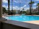 Inviting community pool area with ample seating, lush landscaping, and a relaxing atmosphere for residents to enjoy at 9053 Lee Vista Blvd # 1405, Orlando, FL 32829