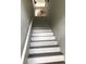 Carpeted stairway leads to the upper level of the home at 9053 Lee Vista Blvd # 1405, Orlando, FL 32829