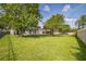 Spacious backyard with lush green grass and privacy fence, creates serene outdoor oasis at 4931 Jetton Dr, Orlando, FL 32837
