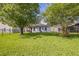 Large backyard features a well-maintained lawn, mature trees, and secure fencing, perfect for outdoor living at 4931 Jetton Dr, Orlando, FL 32837