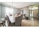 Elegant dining room with a rustic wood table, upholstered chairs, and tile floors at 4931 Jetton Dr, Orlando, FL 32837