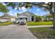Charming single-story home with well-manicured lawn and driveway parked with vehicles at 4931 Jetton Dr, Orlando, FL 32837