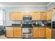 The kitchen shows stainless steel appliances, wood cabinets, and a breakfast bar area at 4931 Jetton Dr, Orlando, FL 32837