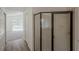 Bathroom featuring a large glass-enclosed shower, neutral walls, and vinyl flooring for a modern look at 4444 Withrowwood Ct, Orlando, FL 32837