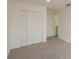 Well-lit bedroom featuring carpet, white walls, and a closet providing ample storage at 4444 Withrowwood Ct, Orlando, FL 32837