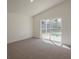 Bright bedroom with plush carpeting and a sliding glass door leading to the pool area at 4444 Withrowwood Ct, Orlando, FL 32837