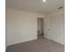 This bedroom with white walls and neutral carpet features a large closet offering ample storage space at 4444 Withrowwood Ct, Orlando, FL 32837