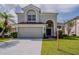Charming two-story home with a well-manicured lawn, two car garage and elegant architectural details at 4444 Withrowwood Ct, Orlando, FL 32837