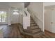 Elegant foyer with staircase featuring stone steps, modern lighting, and sleek flooring at 4444 Withrowwood Ct, Orlando, FL 32837