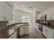 Bright kitchen featuring stainless steel appliances, granite countertops, and sleek white cabinetry at 4444 Withrowwood Ct, Orlando, FL 32837
