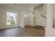 Bright living room featuring a modern staircase, large windows, and sleek flooring at 4444 Withrowwood Ct, Orlando, FL 32837