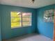 A bedroom with blue walls is shown with a closet at 1629 Lindsey Ter, Deltona, FL 32725