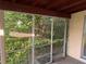 Covered screened in porch with view of backyard landscaping at 1629 Lindsey Ter, Deltona, FL 32725
