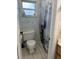 Bright bathroom features a decorative shower curtain, toilet and window with natural light at 3453 Duff Rd, Lakeland, FL 33810