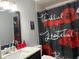 Cozy bathroom with single vanity, modern mirror, toilet, and shower with roses and quote at 3453 Duff Rd, Lakeland, FL 33810