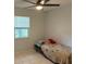 Cozy bedroom features a ceiling fan, a window, and a bed with a playful burrito blanket at 3453 Duff Rd, Lakeland, FL 33810