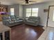 Comfortable living room with wood floors, a ceiling fan and a mix of tile and wood flooring at 3453 Duff Rd, Lakeland, FL 33810