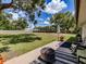 Expansive backyard featuring a lush lawn, a patio area, and mature trees at 6909 Farris Dr, Lakeland, FL 33811