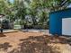 Spacious backyard featuring a basketball court, a wooden deck and mature trees providing ample shade at 6909 Farris Dr, Lakeland, FL 33811