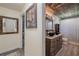 Bathroom with a wood-look ceiling, stained wood vanity with vessel sinks and grey-look flooring at 6909 Farris Dr, Lakeland, FL 33811