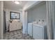 Bathroom with a tub-shower, vanity, and in-unit laundry featuring a full-size washer and dryer at 6909 Farris Dr, Lakeland, FL 33811