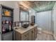 Bathroom featuring wood-look tile flooring, a stained wood vanity, and vessel sinks at 6909 Farris Dr, Lakeland, FL 33811
