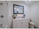Bright bathroom features a white vanity with marble countertop and a shower/tub at 6909 Farris Dr, Lakeland, FL 33811