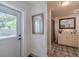 Bathroom with white vanity, gray tile flooring, and a modern mirror at 6909 Farris Dr, Lakeland, FL 33811