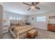 Primary bedroom with a king-sized bed, ceiling fan, and plantation shutters at 6909 Farris Dr, Lakeland, FL 33811
